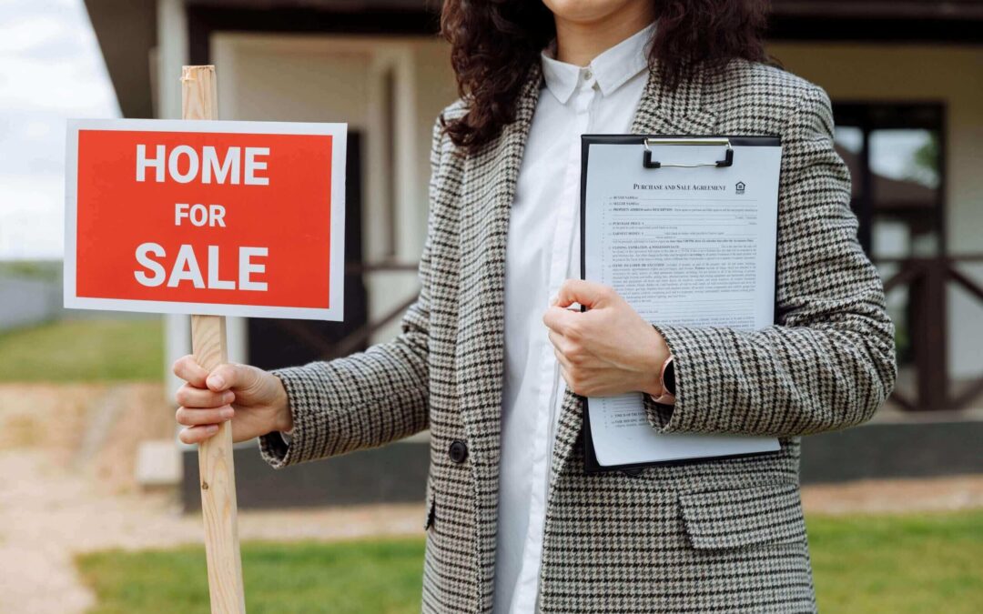 real estate agent puts home for sale